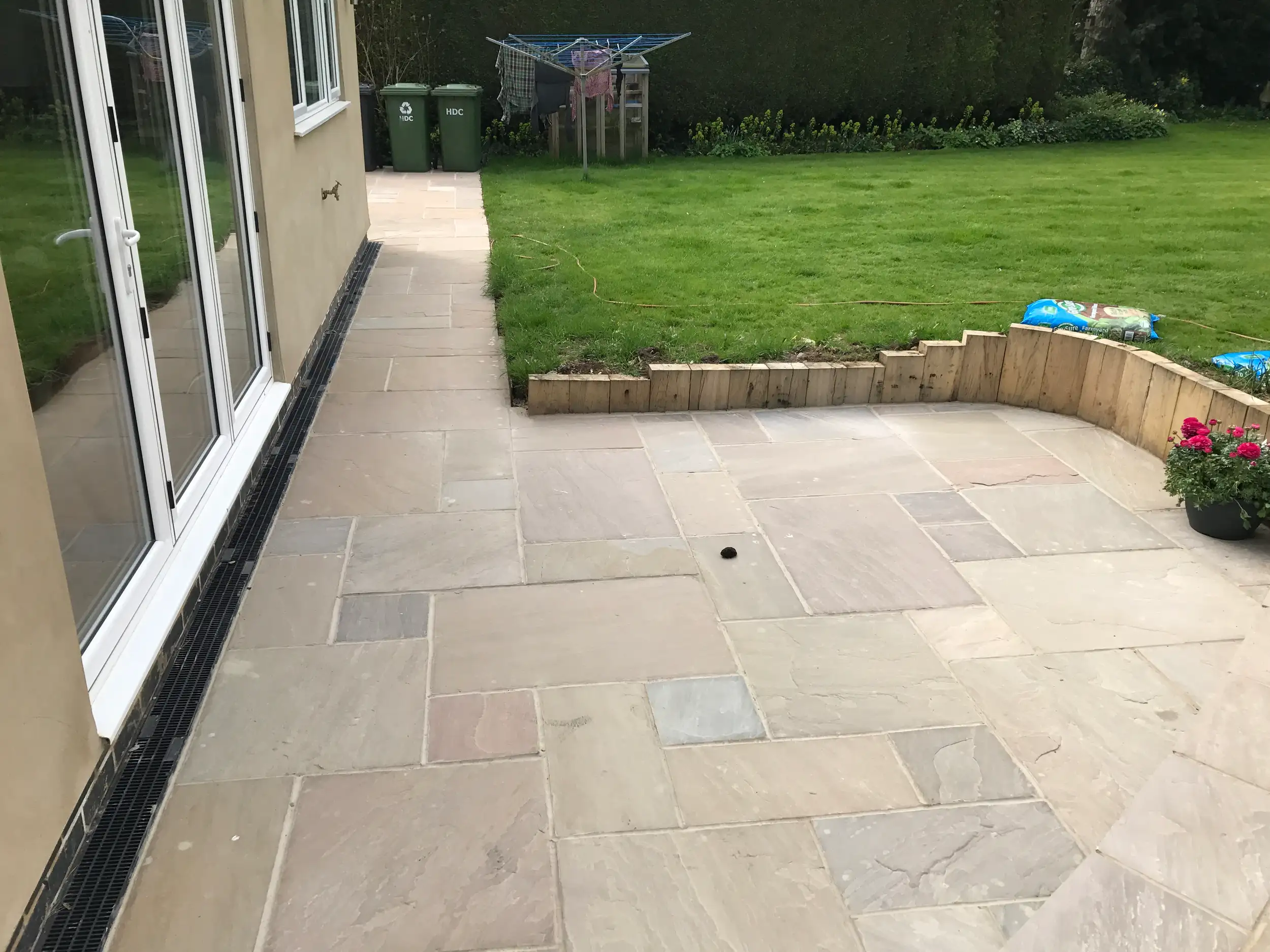 Sandstone patio with sleeper retaining walls